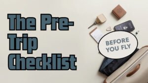 A passport, boarding pass, phone checklist and packed carry-on laid out flat while preparing for an international trip